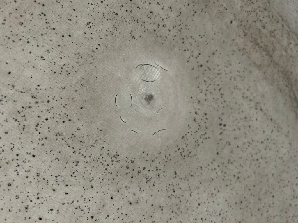 cracked spot on a PVC roof membrane resulting from hail damage after a storm