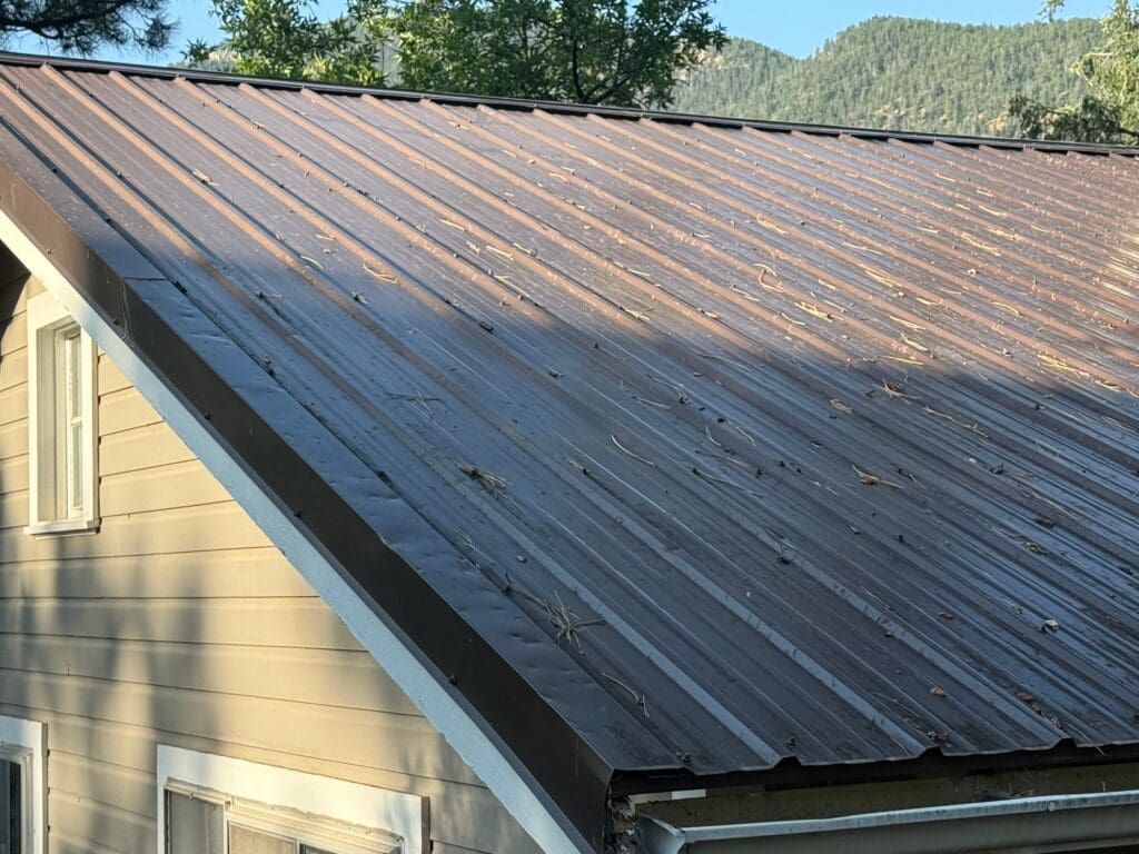 metal roof with an exposed fastener system that was dented and damaged by a hail storm